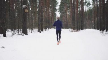 Running Man In Sportswear Workout Before Triathlon. Winter Sports Concept