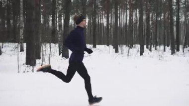 Running Man In Sportswear Workout Before Triathlon. Winter Sports Concept