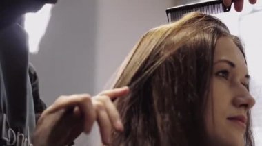Beautiful girl with brown hair in a hair salon