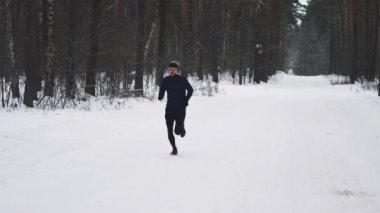 Running Man In Sportswear Workout Before Triathlon. Winter Sports Concept