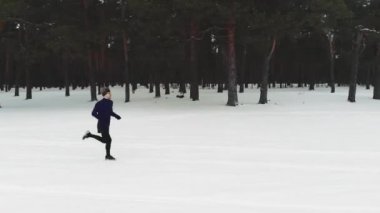 Running Man In Sportswear Workout Before Triathlon.Winter Sports Concept. Aerial