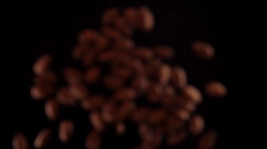 Bademler siyah bir zeminde yukarı aşağı uçar. Bademlerle sağlıklı yiyecekler pişirirler..