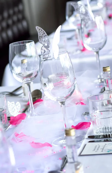 Elegant wedding table setup with wine glasses and cutout butterflies