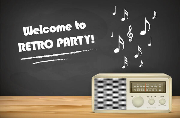 Retro radio on wooden tabletop and chalkboard with copy space