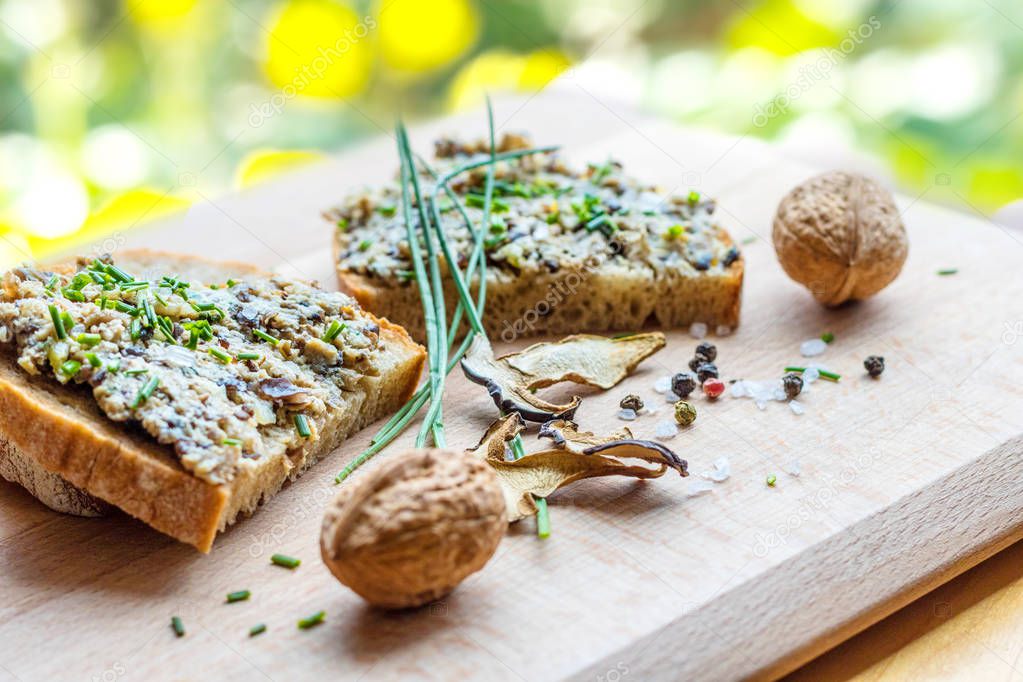 Bread slices with spread, chives, nuts, mushroom and condiment