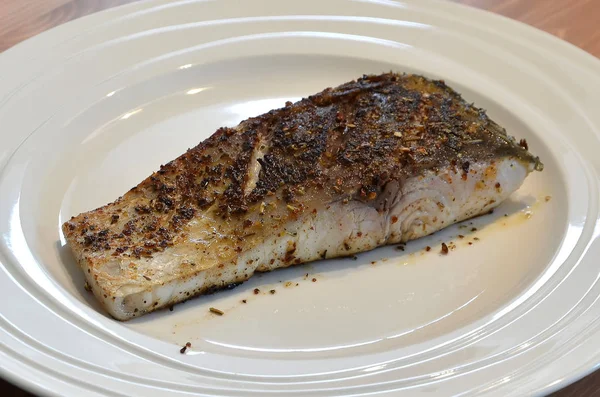 Gebratener Fisch mit Gewürz auf weißem Teller Detailfoto — Stockfoto