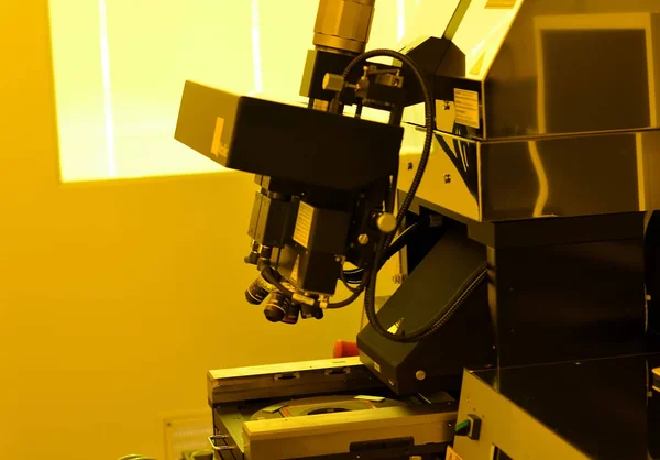 microscope in laboratory under the yellow light for working with