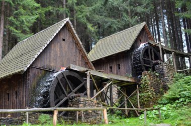 two old wooden water mill with mill-wheel detail photo