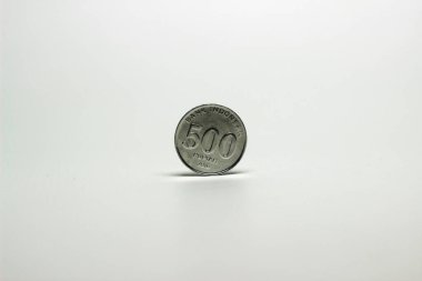 Bozuk para beyaz arkaplanın önünde duruyor. 500 kişilik Endonezya Rupiası.
