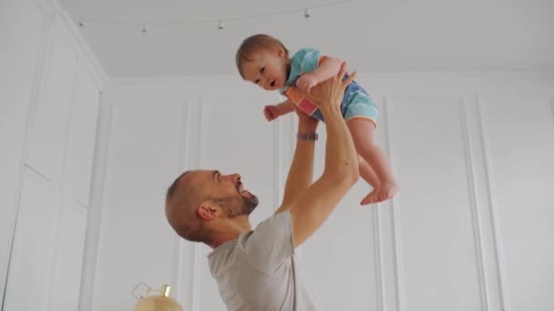 Счастливый отец бросает маленького сына, мальчика и отца веселиться — стоковое видео
