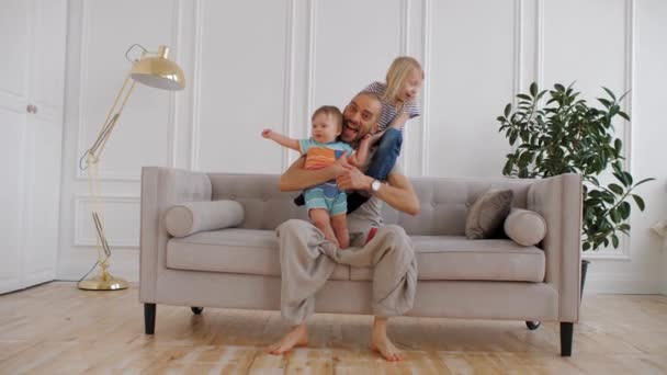 Gelukkige familie die samen tijd doorbrengt, zich verheugt, thuis speelt, plezier heeft — Stockvideo