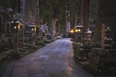 Ancient Cemetery at night inside a forrest, Okunoin Cemetery, Wakayama, Japan. clipart