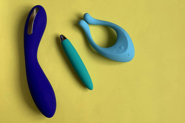 Vibrators. Three sex toys on a yellow background. Useful for sex shop