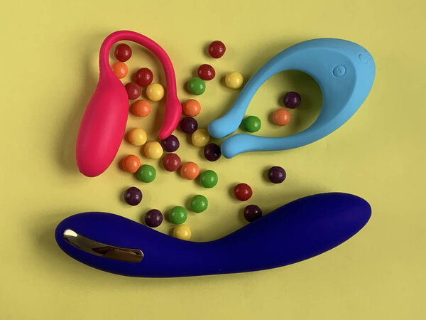 Three sex toys. Vibrators on a yellow background. Useful for sex shop or adults