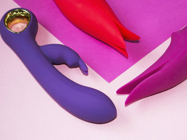Vibrators. Tree sex toys with vibration on a pink background. Dildos with vibration.  Useful for adult, sex shop