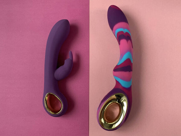 Vibrators. Two vaginal dildos with vibration on a pink background. Sex toys.  Useful for adult, sex shop.