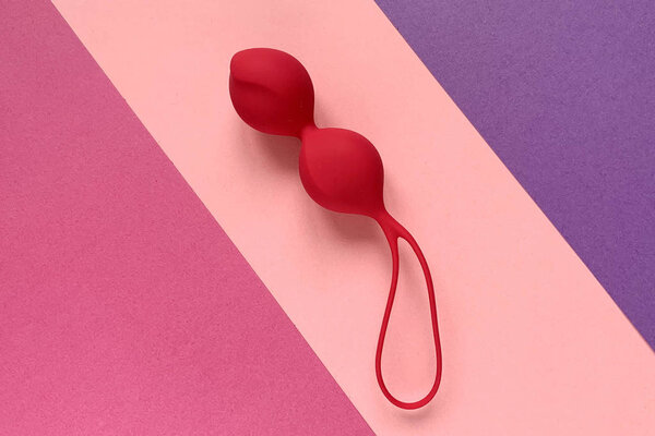 Adult toys. Red jiggle balls on a color background. 