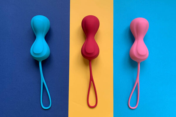 Adult toys. Three jiggle balls on a color background. 
