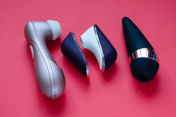 Sex toys. Clitoral suction vibrators on a red background. Useful for sex shop