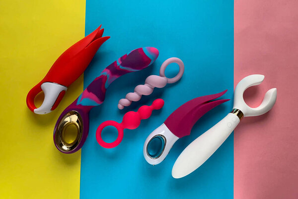 Sex toys. Vibrators and butt plugs on a color background. Useful for sex shop