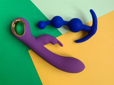 Sex toys. Vibrator and butt plug, color background. Useful for adult, sex shop
