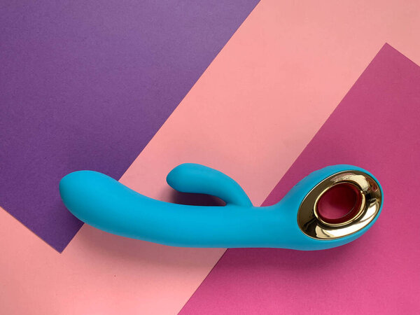 Sex toy. Blue vibrator on a color background. Useful for adult