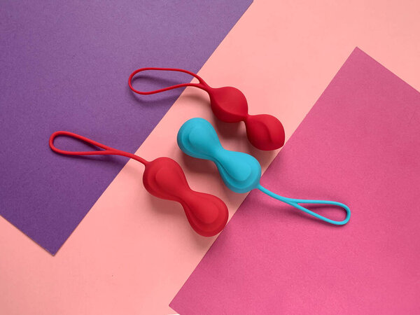 Sex toys. Ben wa balls on a color background. Useful for sex shop, adults.