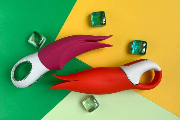 Sex toys. Pink and red vibrators on a color background. Useful for sex shop, adult