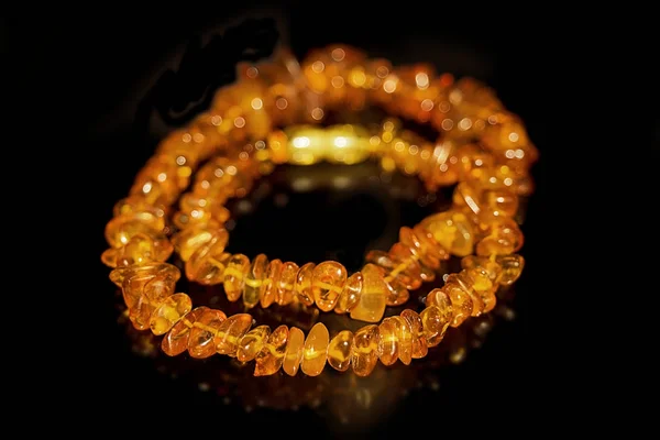 Feminine amulet on the neck of amber — Stock Photo, Image