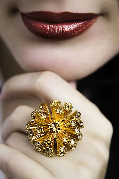 Beautiful ring in female red lips — Stock Photo, Image