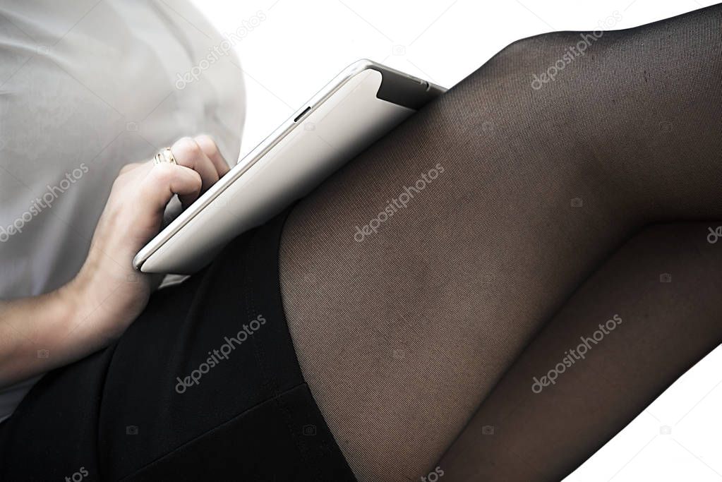 girl in a short skirt working on a tablet