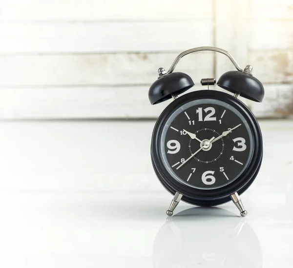 Alarm clock against wooden — Stock Photo, Image
