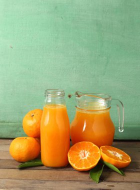 Group of fresh orange and juice on wooden table