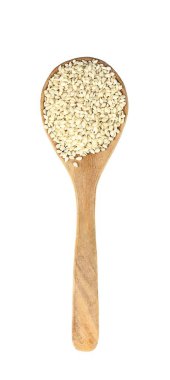 Top view of white sesame on wooden spoon