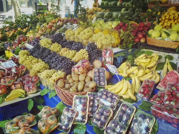 Large counter in the market with a variety of fruits and berries