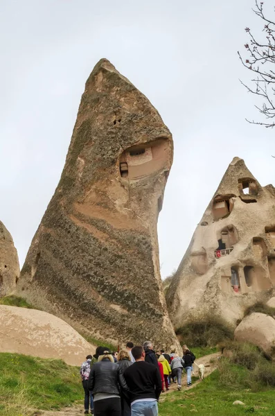 Uchisar, Turkey - April 15 - 2019: A group of tourists goes along the path in the national park Goreme — Stock Photo, Image