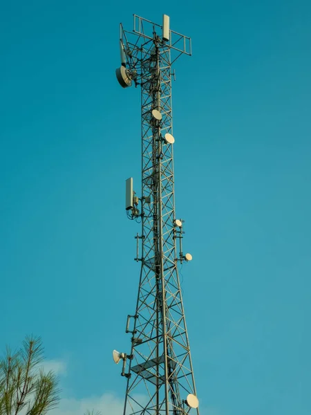 Cell tower against a blue sky. Satellite communications and telecommunications