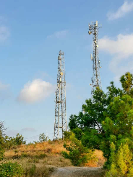 Two cellular tower on a background of a nature of a countryside