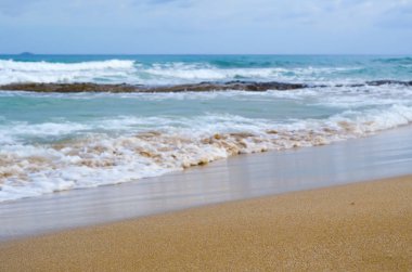 Sandy beach with a blurred background waves