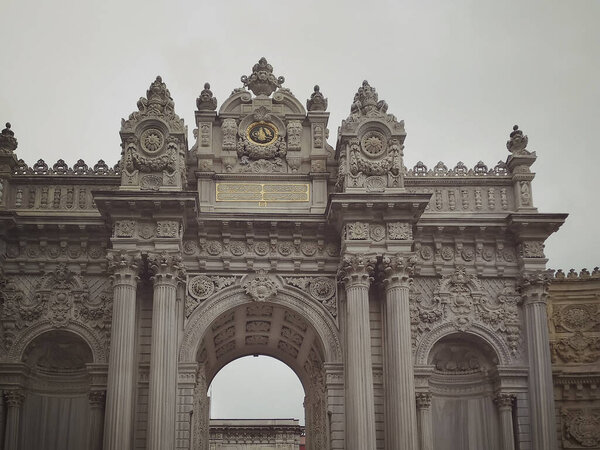 Fragment of the main gate of the Dolmabahche Palace complex on a cloudy day