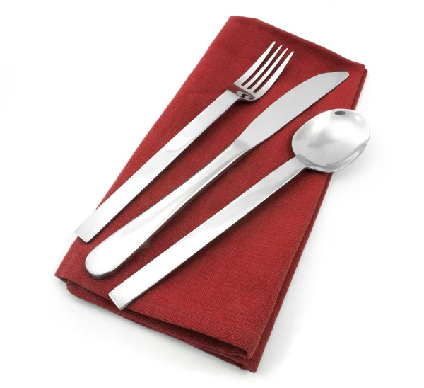 Widelec i nóż na czerwony serwetka na białym tle — Zdjęcie stockowe