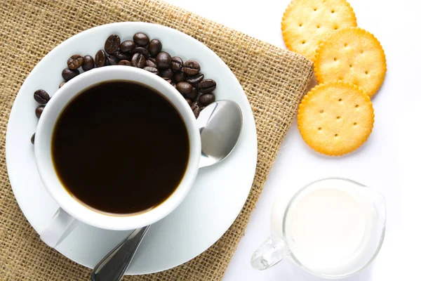 Cup of coffee and milk with biscuit