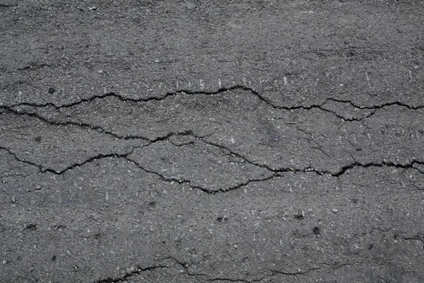 Crack background texture of rough asphalt — Stock Photo, Image