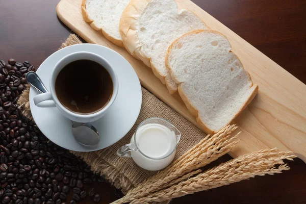 Taza de café y granos de café en la mesa —  Fotos de Stock