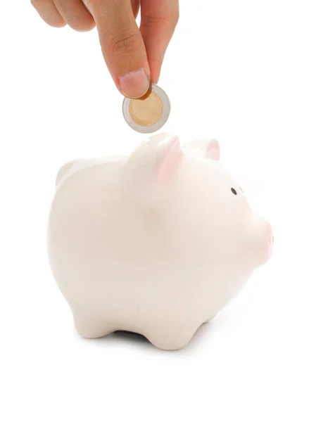 Hand een munt ingebruikneming piggy bank — Stockfoto