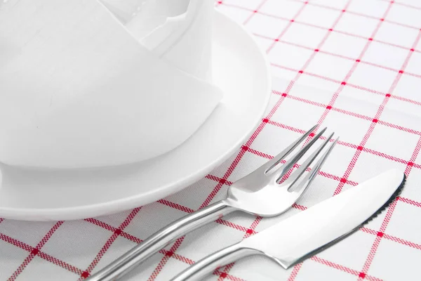 Plate fork and knife on red napkin — Stock Photo, Image