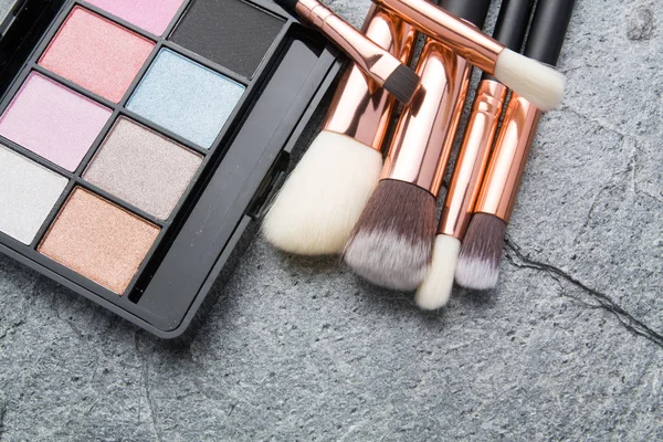 various makeup products on dark background