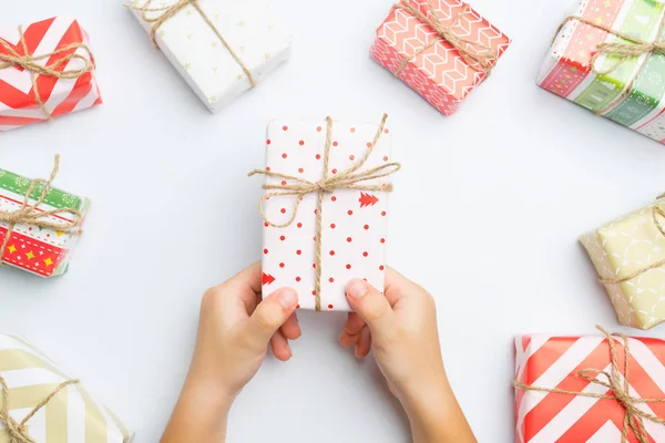 Kid holding christmas presents  on white — Stock Photo, Image