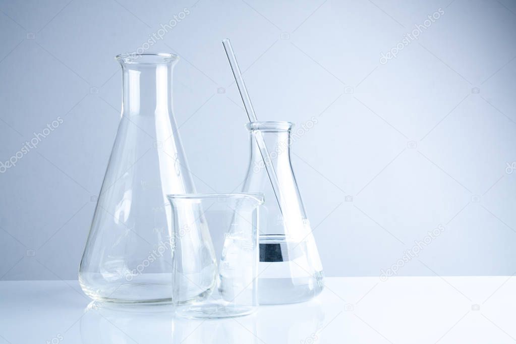 Laboratory glassware on table, Symbolic of science research.