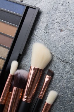 koyu arka plan üzerinde çeşitli makyaj ürünleri 